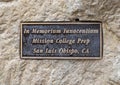 Dedication plaque on the side of a carved stone sculpture in a garden at the Catholic Church of Saint John the Baptist in Edmond. Royalty Free Stock Photo