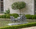 Detailed bronze sculpture of a horse drawn carriagne in the front of a mansion in Highland Park, Dallas, Texas. Royalty Free Stock Photo