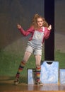 Eleven-year old girl dancing on stage in school play