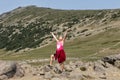 Eleven year-old Caucasian standing with arms and face uplifted to the sky along a trail in Mount Rainier National Park, Washington