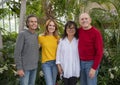 Family posing in front of beautiful plants and flowers on Mother`s Day.