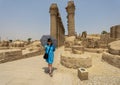 Female Korean tourist before the Colonnade Hall of Amenhotep III and Tutankhamun from the Amenhotep III Court of the Luxor Temple.