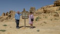 Tourists with painted steel sign for Gebel Al Mawta, the `Mountain of the Dead`, in Siwa Oasis, Egypt.