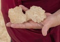 Korean female tourist holding large salt crystals beside one of the beautiful salt pools around the Siwa Oasis in Egypt.