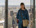 Female Korean tourist posing in the immersive art experience of SUMMIT One Vanderbilt in New York City. Royalty Free Stock Photo