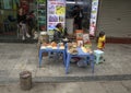 Vietnamese street vendor in Hanoi, selling food from plastic sidewalk tables Royalty Free Stock Photo