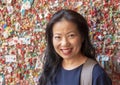 Korean woman in front of The Market Theater Gum Wall, Pike Place Market, Seattle, Washington