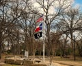 Flags and inscribed stone at the Prisoner of War Veteran`s Memorial in Sparger Park in Colleyville, Texas.