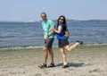 Husband and wife having fun walking on Alki Beach, Seattle, Washington