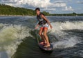 Fourteen year-old Amerasian boy wake surfing on Grand Lake in Oklahoma.