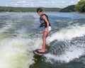 Fourteen year-old Amerasian boy wake surfing on Grand Lake in Oklahoma.