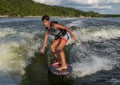 Fourteen year-old Amerasian boy wake surfing on Grand Lake in Oklahoma.