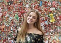 Teenage girl in front of The Market Theater Gum Wall, Pike Place Market, Seattle, Washington