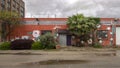 Vegetation mixed with a flower mural by Campagna on the front of a business in Deep Ellum, Texas.