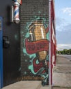 Graffiti style mural advertising a barbershop in Oak Cliff, Texas.