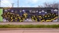 Dog bathing Mural by unidentified artist on a building wall on Singleton Blvd. in Dallas, Texas