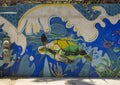 Grafitti Style mural featuring a sea turtle in the ocean on a sidewalk off La Plaza in San Jose del Cabo.