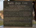 Granite stone base of a double life-size memorial to Kelli Ann Cox by Tom White on the campus of the University of North Texas.