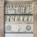 High relief representing the Stories of Saint Martin above the Labor of the Months July through December at Lucca Cathedral.