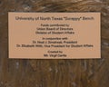 Information plaque for `Scrappy Bench` by Virgil Oertle on the campus of the University of North Texas in Denton, Texas.