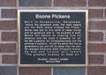 Information plaque for statue of Boone Pickens outside the football stadium of Oklahoma State University in Stillwater, Oklahoma.