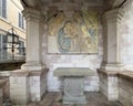 Interior or a small outdoor chapel with an ancient fresco of Madonna and Child in Assisi, italy.