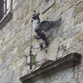 Iron winged dragon lamp above a doorway of the Captain\'s Palace in the Republic square of Cortona, Italy.