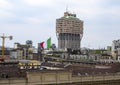 Italian flag atop the Royal Palace and the skyline of Milan as viewed from the rooftop of the Milan Cathedral.