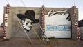 John Wayne and six `Adobe is Political` posters on a painted wall in Marfa, Texas.