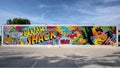Large and brightly colored mural on the side of the Sugar Shack Spa and Salon in Arlington, Texas.
