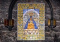 Large image of the Black Madonna on painted tiles along the Ave Maria Path in the Basilica at Santa Maria de Montserrat Monastery.