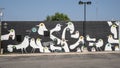 Large mural featuring birds painted on an outside brick wall of a business in the Plaza District of Oklahoma City by Skip Hill.