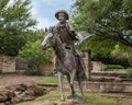 Cowboy on horseback, a bronze sculpture by Anita Pauwels, part of a public art installation titled `Cattle Drive` in Central Park