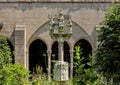 The limestone cross with Apostles in the Trei Cloister Garden in New York City.
