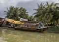 Long houseboat moored along the bank of the Thu Bon River in Hoi An, Vietnam