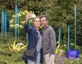 Husband and wife take a selfie before an outdoor exhibit in the garden, Chihuly Garden and Glass in the Seattle Center