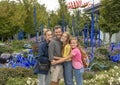 Family posing before outdoor exhibit in the garden, Chihuly Garden and Glass in the Seattle Center