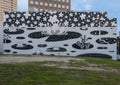 Monumental mural by Will Heron titled `Intergalacti` on the back of the property at 3203 McKinney Avenue in Dallas, Texas.