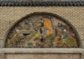 Mosaic tile painting of master artisan on the brick outside wall of Art Naji in Fez, Morocco.