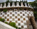 Mosaic tiled wall flanking entry staircase to Park Guell in Barcelona, Spain..
