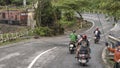 Motorcycles with passengers restarting after stopping for the train to pass, Hai Van Pass, Vietnam Royalty Free Stock Photo