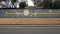 Mural on a barrier wall between Forest Lane and the neighborhood on the North side, painted in 1976 by art students.