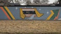 Mural on a barrier wall between Forest Lane and the neighborhood on the North side, painted in 1976 by art students.