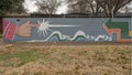 Mural on a barrier wall between Forest Lane and the neighborhood on the North side, painted in 1976 by art students.