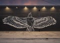 Mural featuring a bird with outstretched wings on an outside wall of a business in Deep Ellum, Dallas.