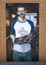 Mural featuring John Lewis of Lewis Barbecue on an outside brick wall of Cattleack Barbecue in Dallas, Texas.