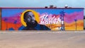 Mural featuring Nipsey Hussle on the side of a restaurant in Glendale Shopping Center in Dallas, Texas.