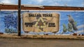 Pictured is a mural on the side of a business in Dallas, Texas, featuring the state flower, the state bird, and the longhorn steer