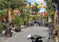 Narrow shopping street with colorful lampshades in Hoi An, Vietnam