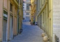 Narrow street with Graffiti decprated door at the end in Genoa, northern Italy